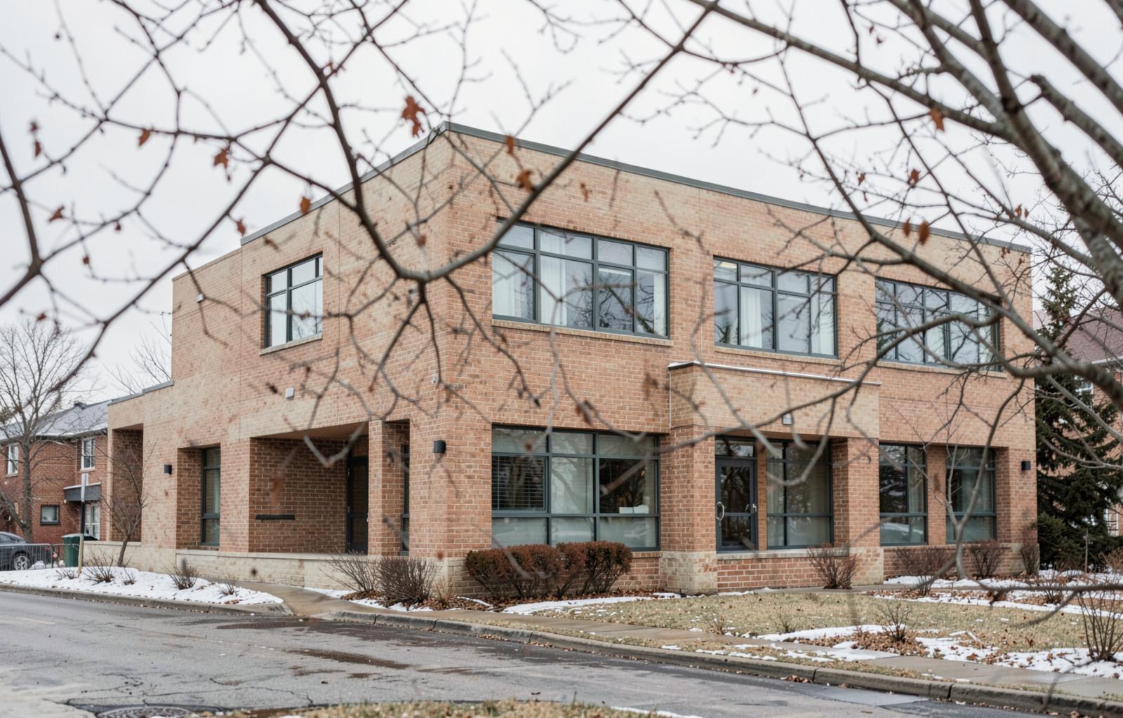 A quiet brick office building in a Canadian suburb in winter, where Amir Software Inc. is based